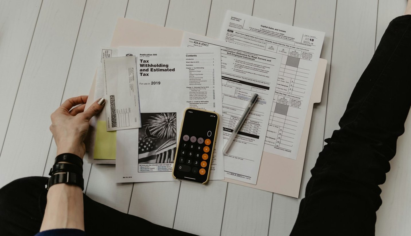 Paper records and calculator on a local desk